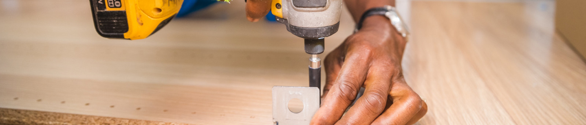 photograph worker attaching bracket to board